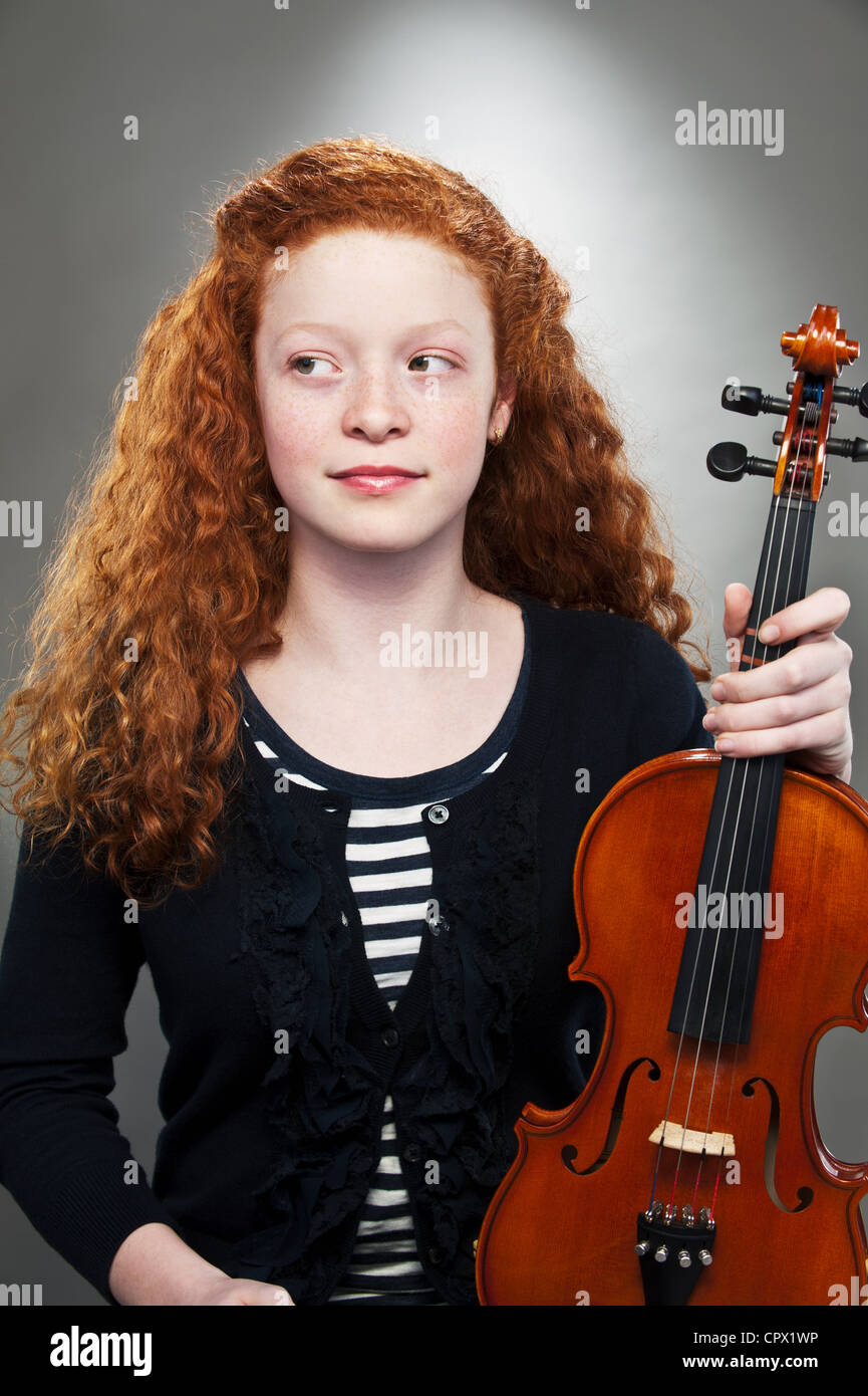 Young mixed race teenage girl holding violin Stock Photo - Alamy