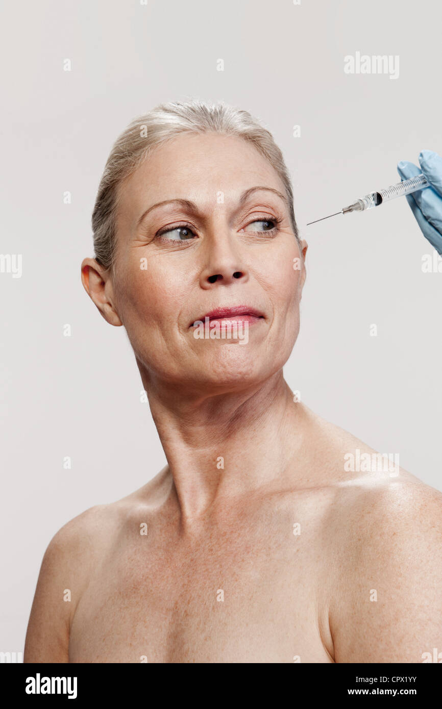 Mature woman receiving injections Stock Photo