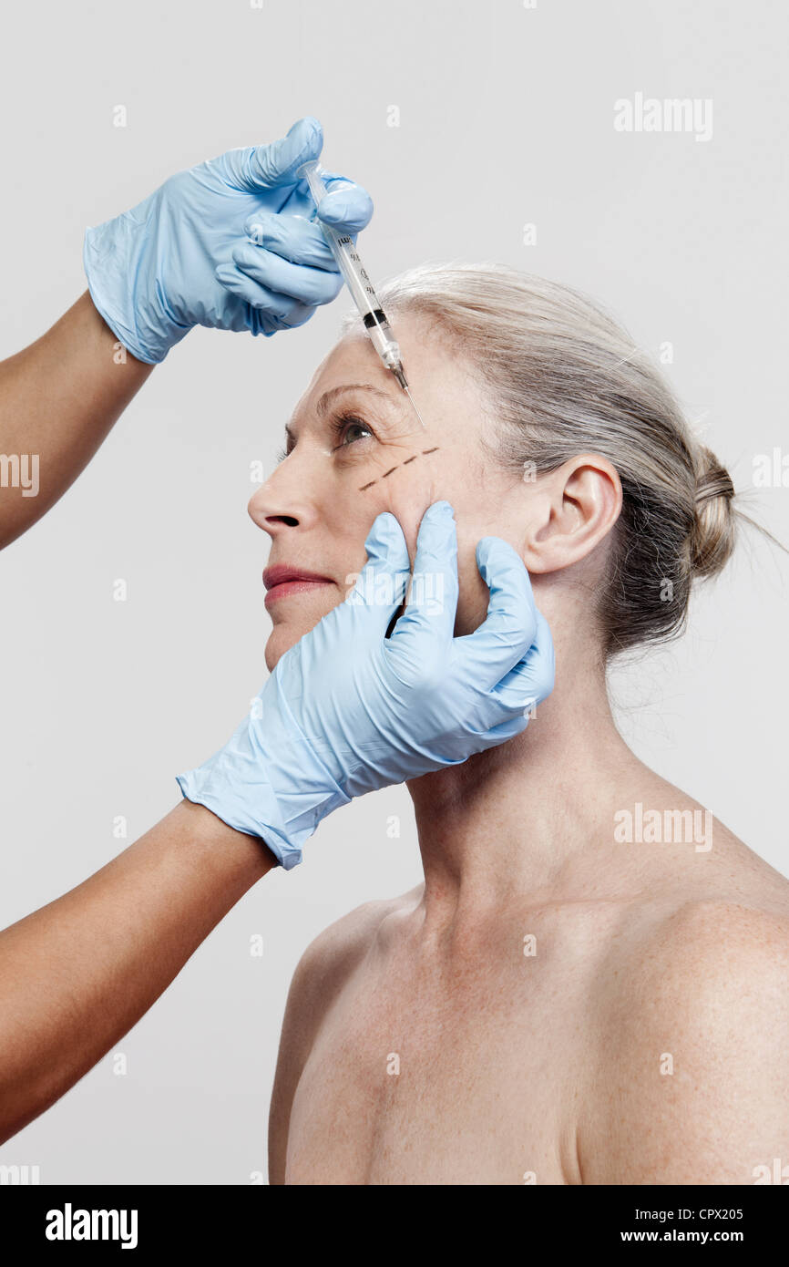 Mature woman receiving injections Stock Photo