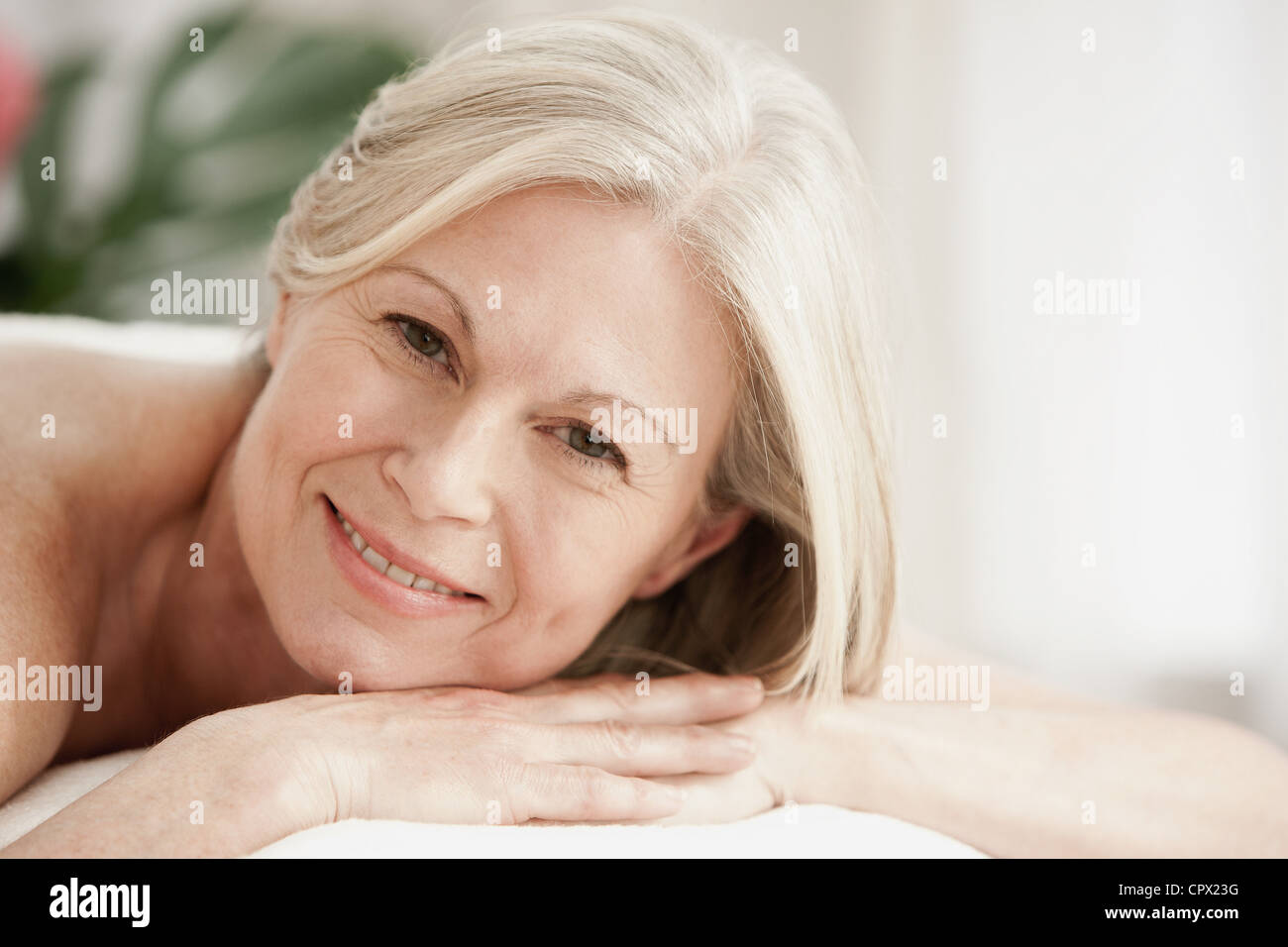 Portrait of mature woman on massage table Stock Photo