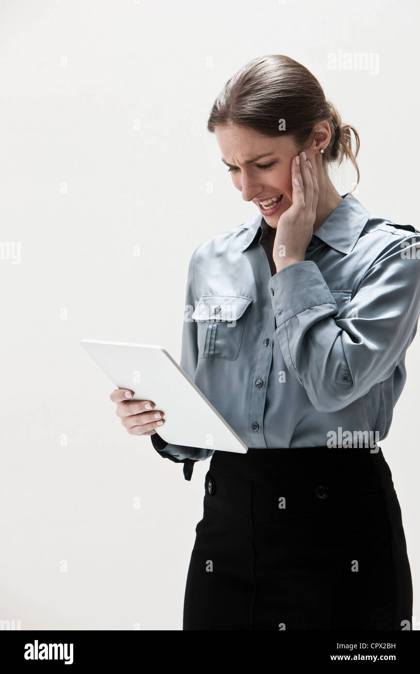 Young businesswoman using digital tablet, studio shot Stock Photo