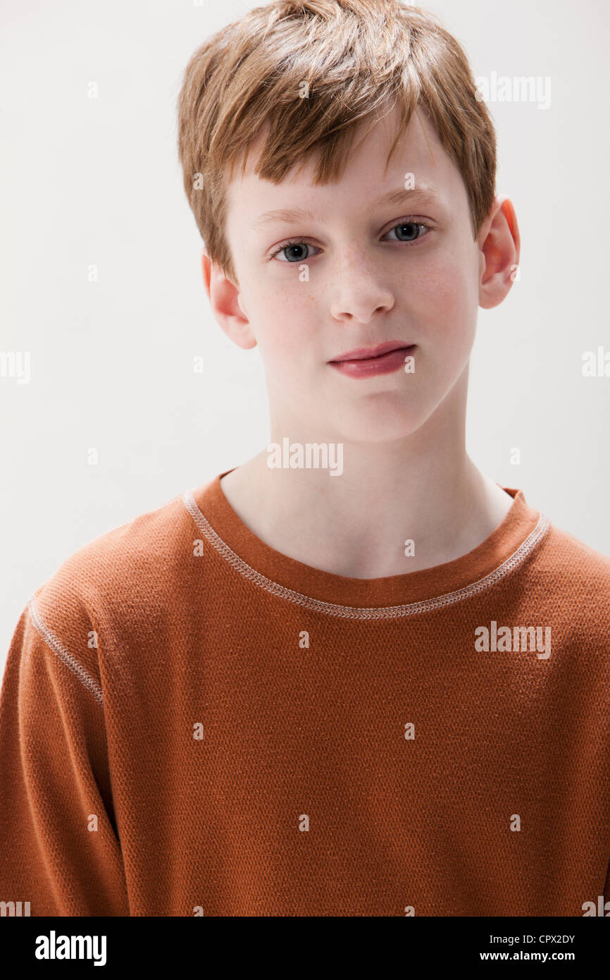 Portrait of boy in brown sweater, studio shot Stock Photo