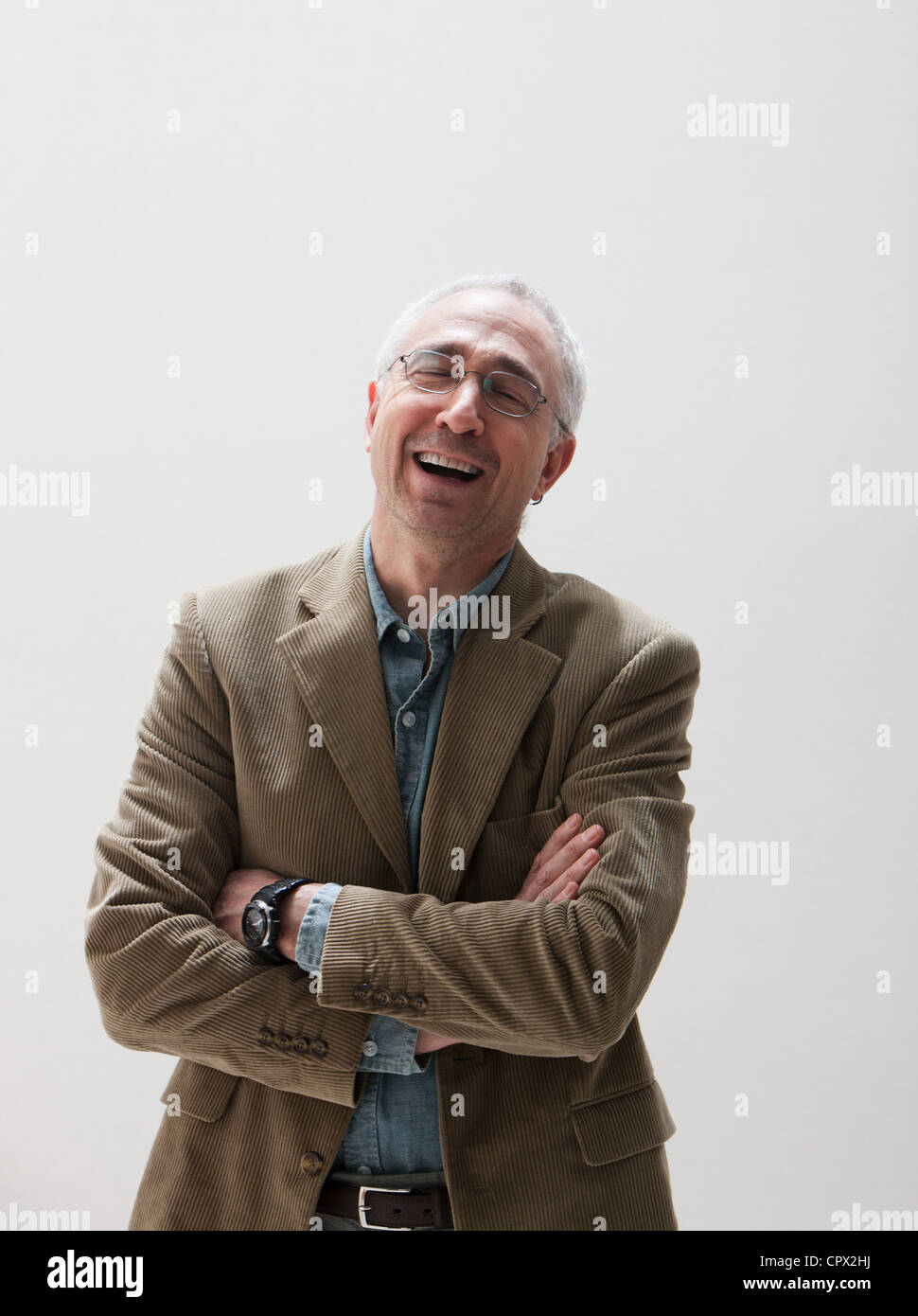 Mature man laughing, studio shot Stock Photo