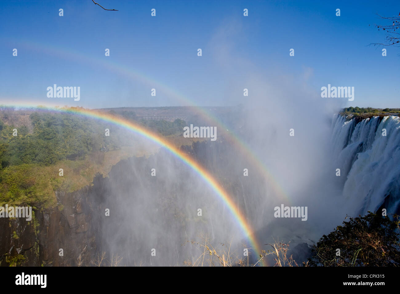 Rainbows over Victoria Falls Stock Photo