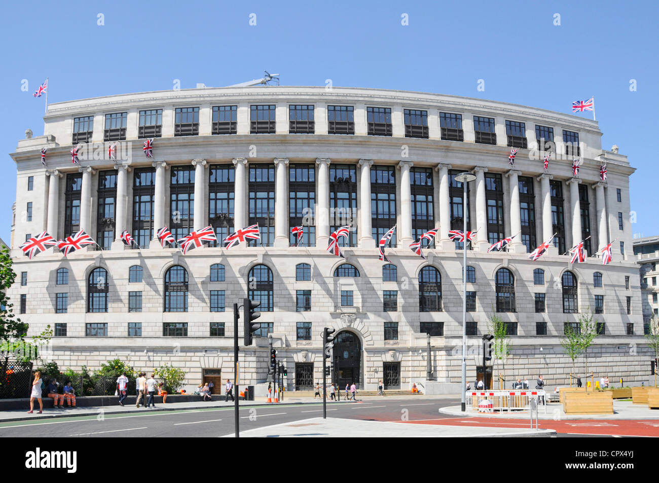 Unilever House headquarters curved Neoclassical Art Deco office building frontage facade with union jack flags Blackfriars City of London England UK Stock Photo
