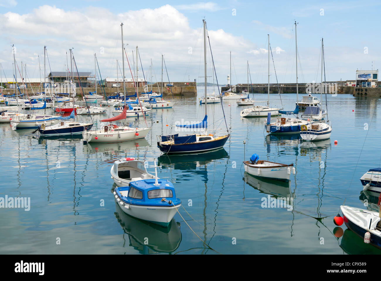 Penzance harbour boats calm still sea water reflections. Stock Photo
