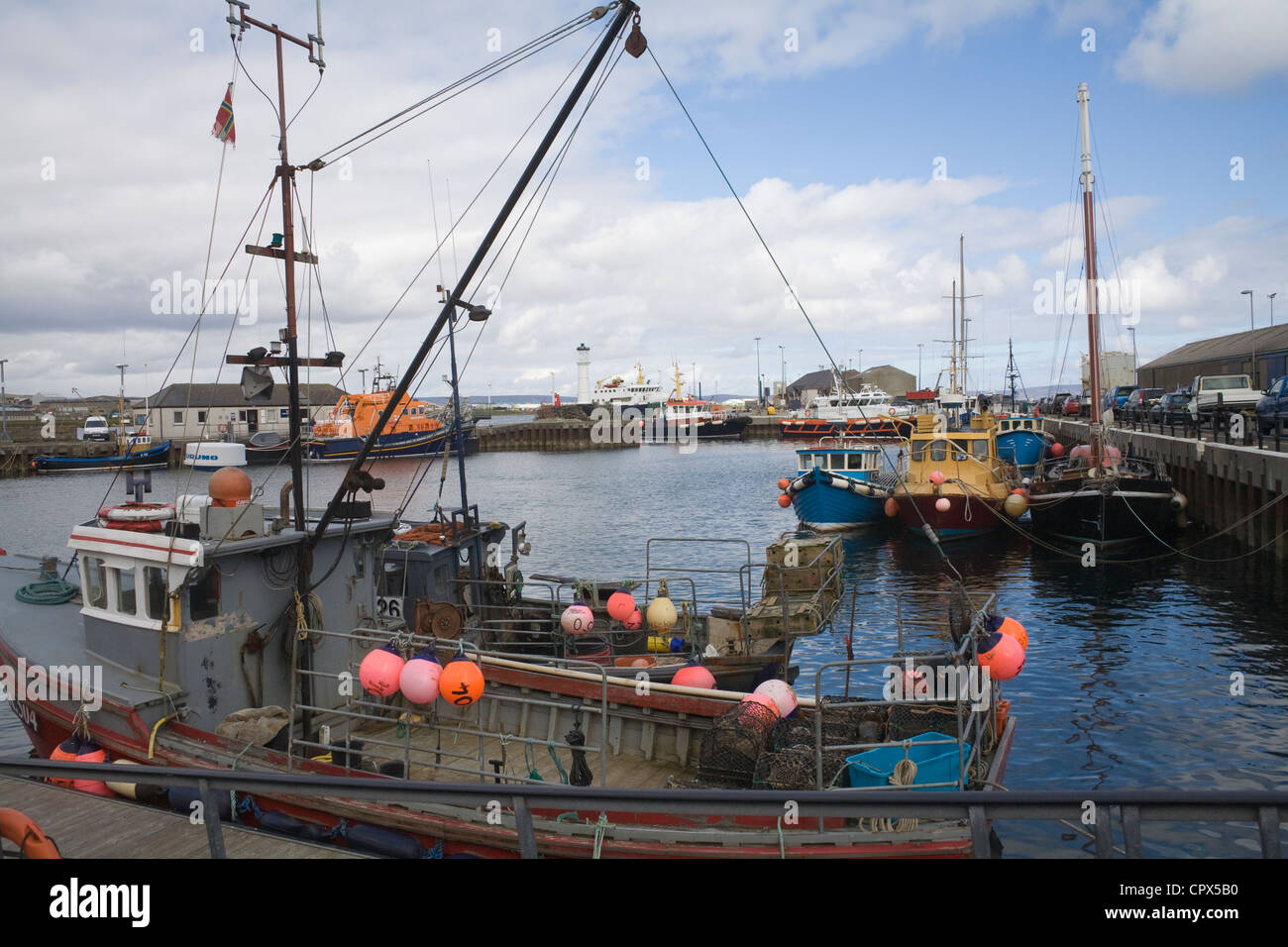 Kirkwall Orkney Islands UK Fishing boats and lifeboat moored in the harbour capital town on lovely May day weather Stock Photo