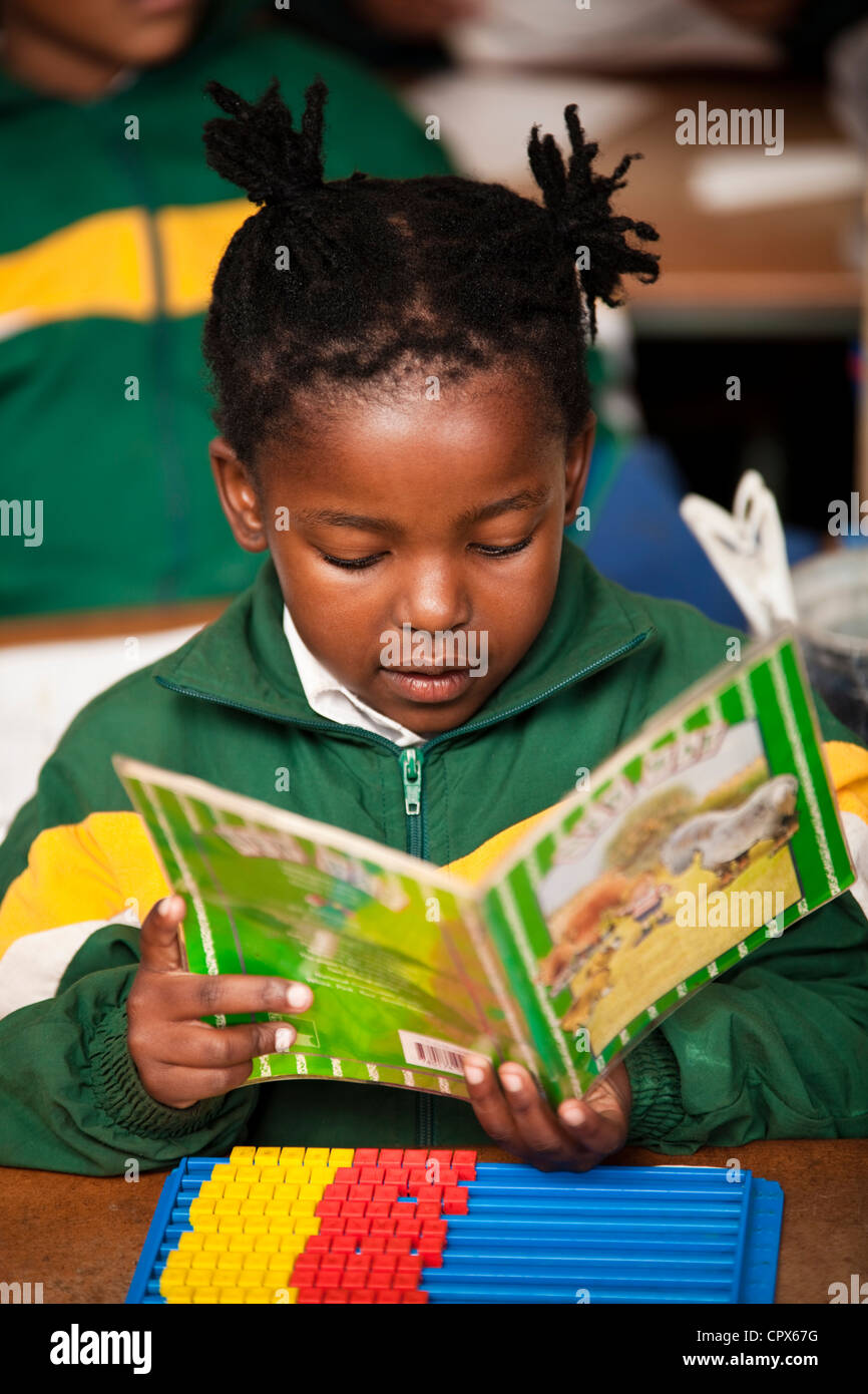 A young girl reading a book at school, Meyerton Primary School, Meyerton, Gauteng Stock Photo
