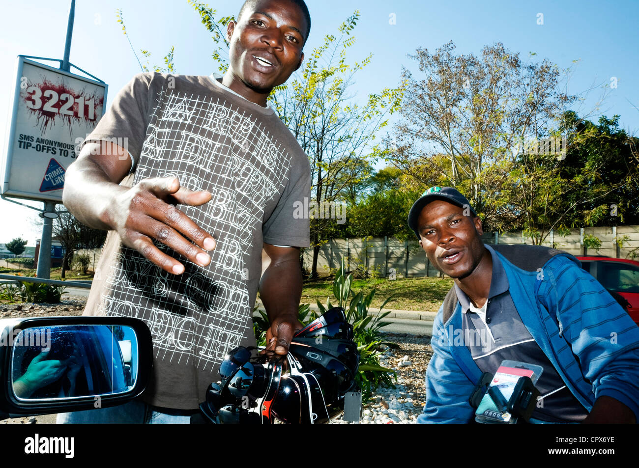 Two hawkers selling sunglasses on the roadside Stock Photo