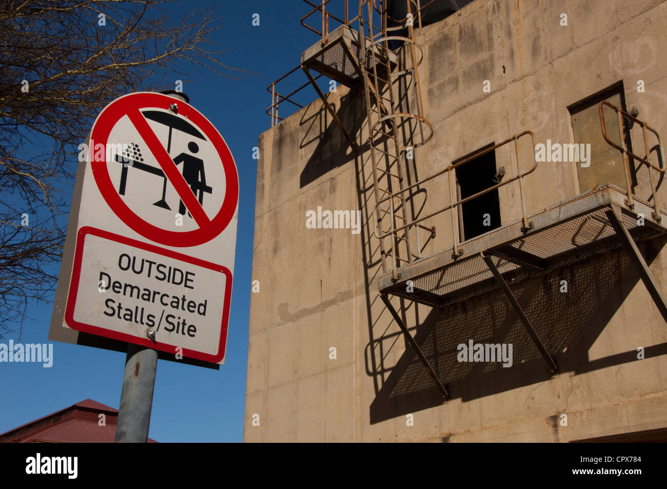 Landscape shot of a building with a no hawkers street sign outside Stock Photo