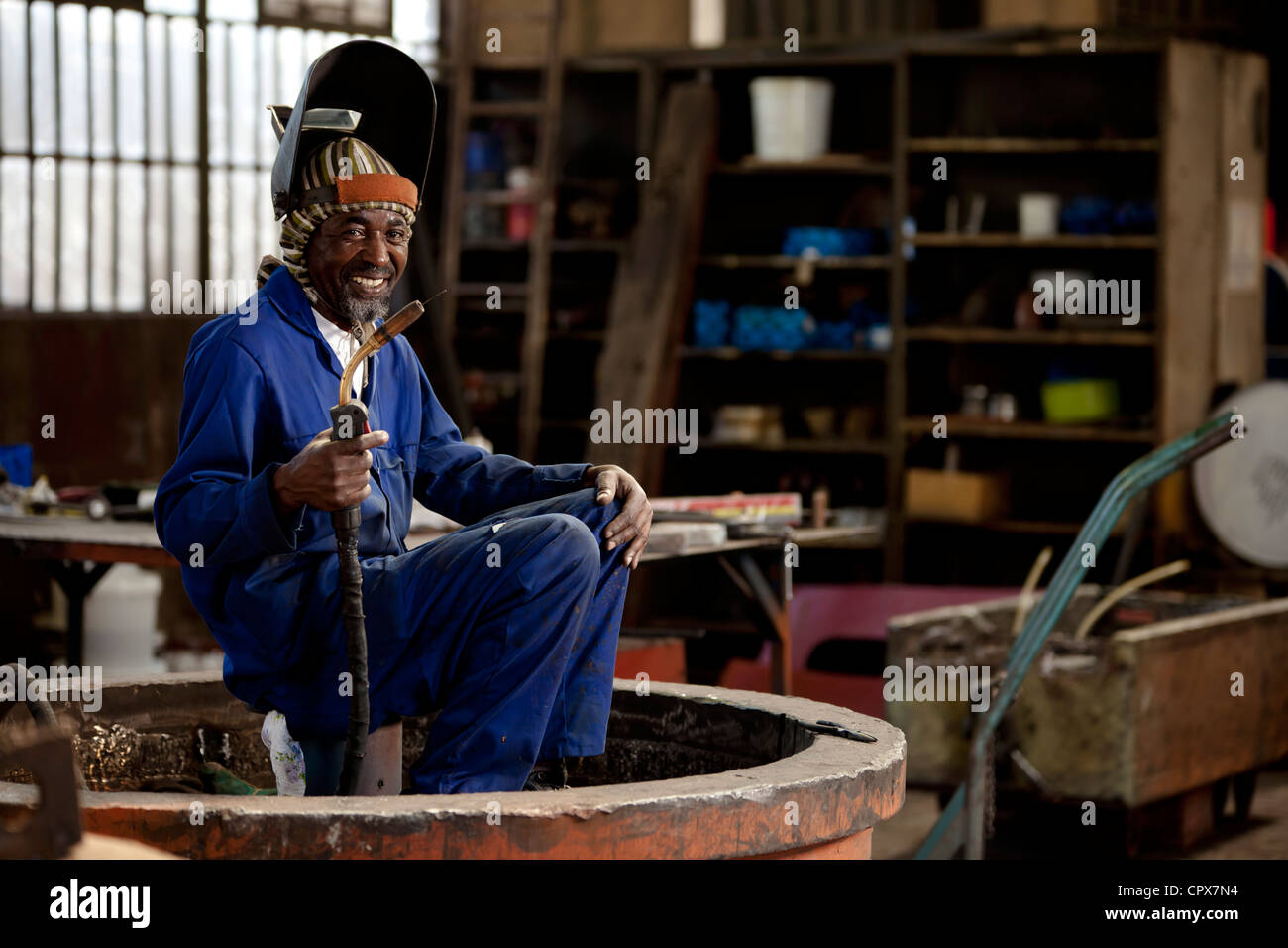 Welder smiling in a magnet factory, Gauteng, South Africa Stock Photo