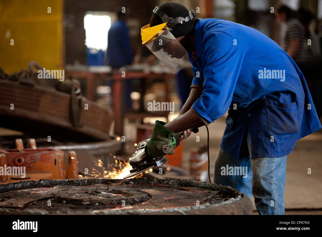 Grinding an industrial magnet in a magnet factory, Gauteng, South Africa Stock Photo