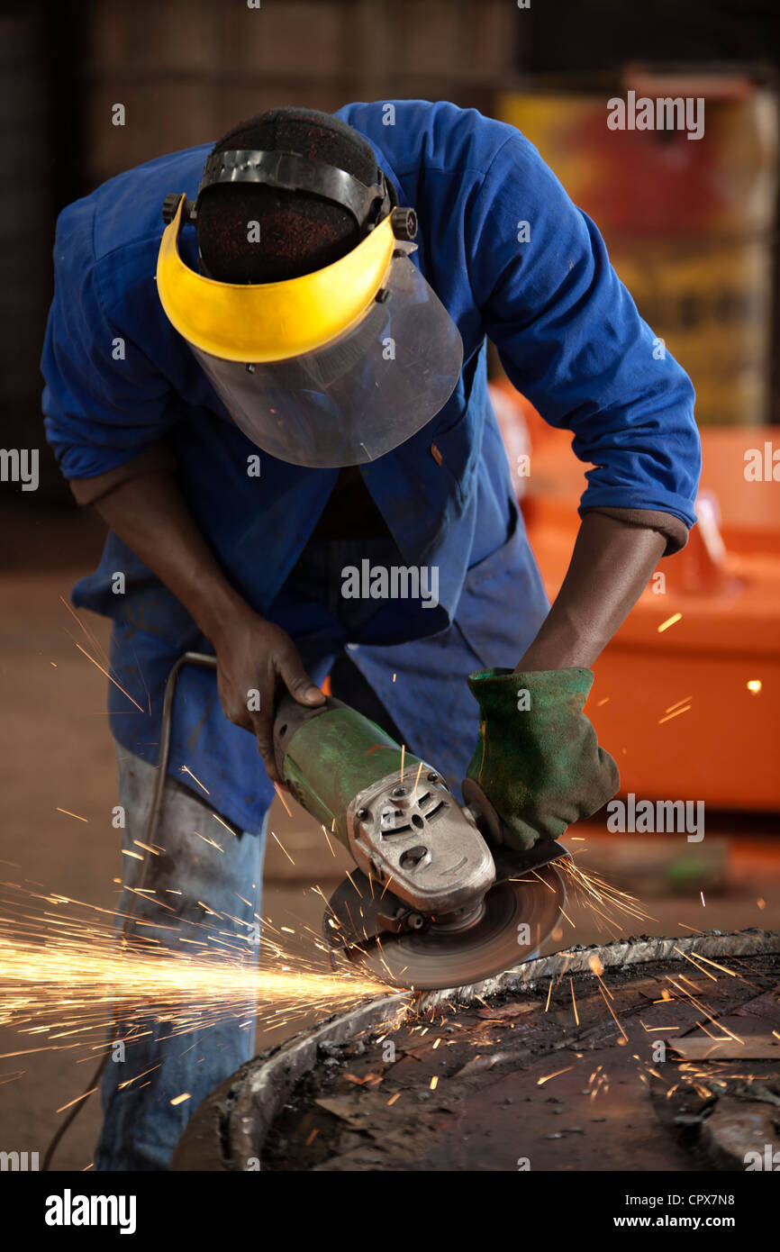 Grinding an industrial magnet in a magnet factory, Gauteng, South Africa Stock Photo