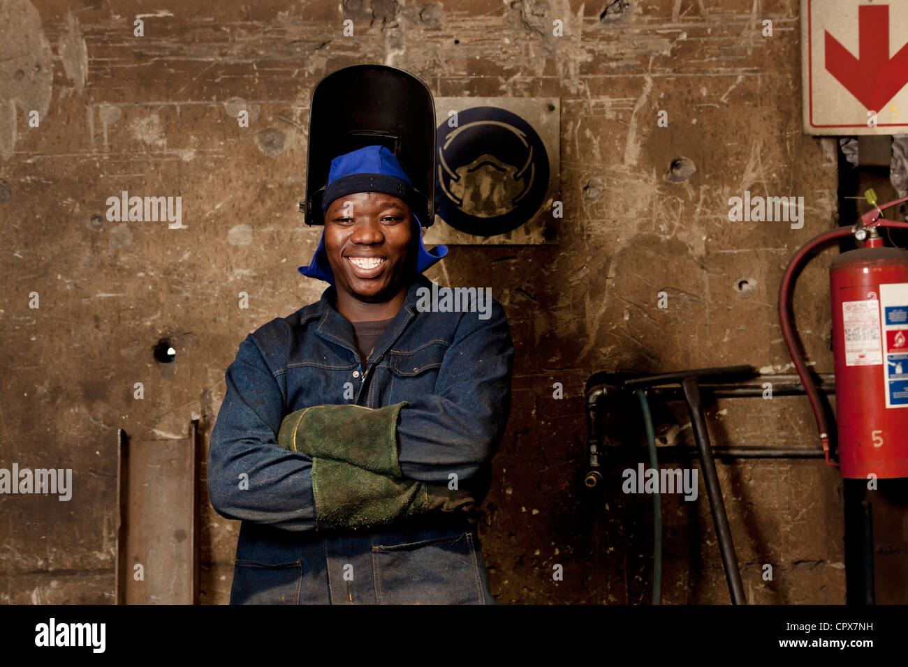 Factory worker posing in welding helmet, factory, Gauteng, South