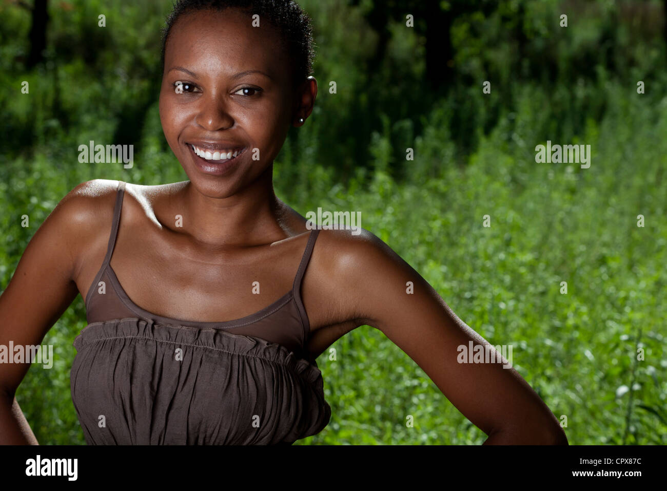 Young adult funky black female standing outside smiling at camera Stock Photo