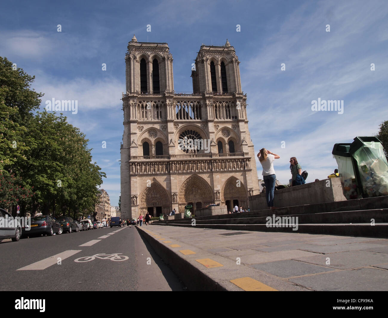 Low angle street and pavement view of Notre Dame, Paris, France, May 10, 2012, © Katharine Andriotis Stock Photo
