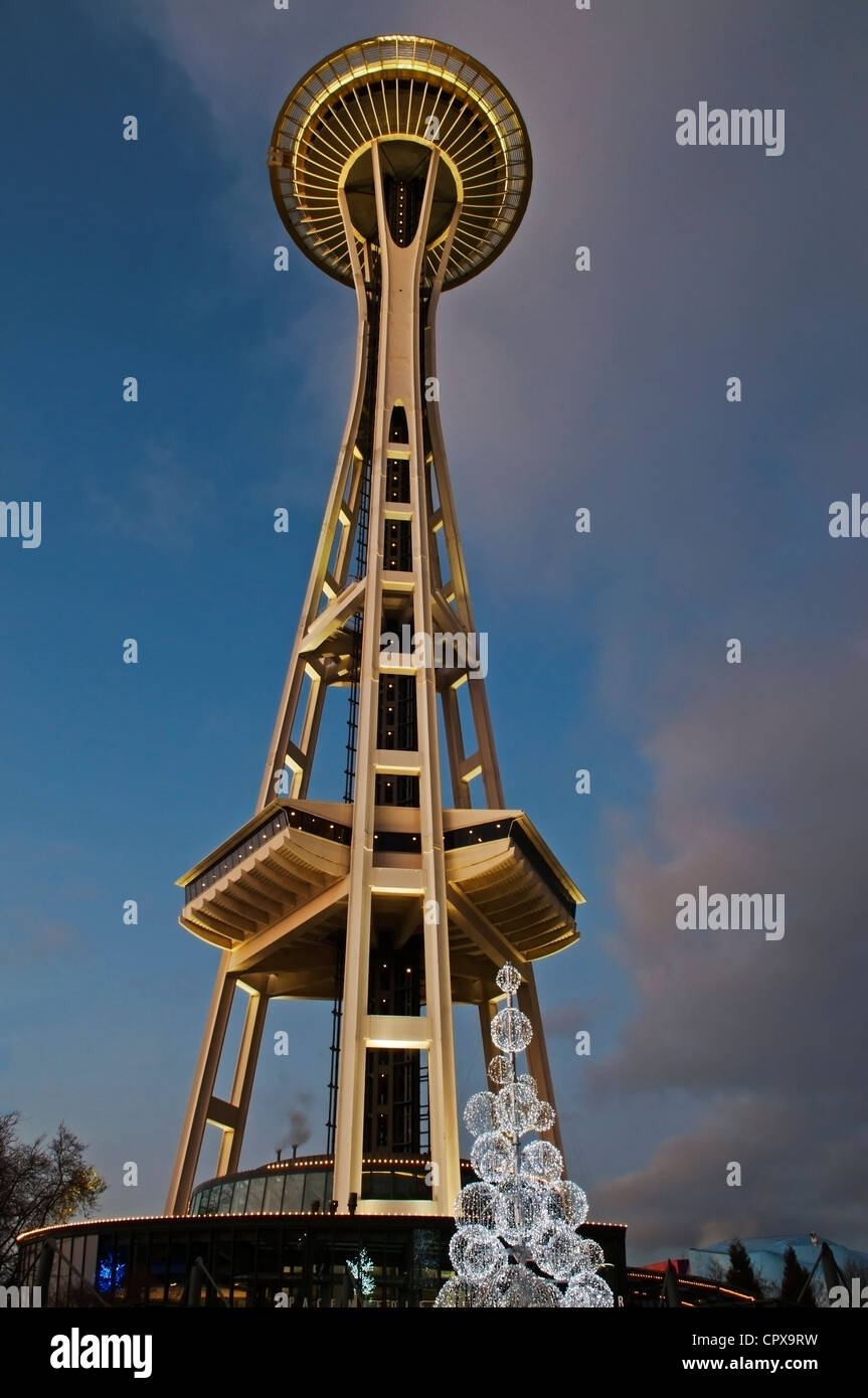Upward view of the Seattle Space Needle and illuminated tree lights at twilight during the festive Christmas season. Stock Photo
