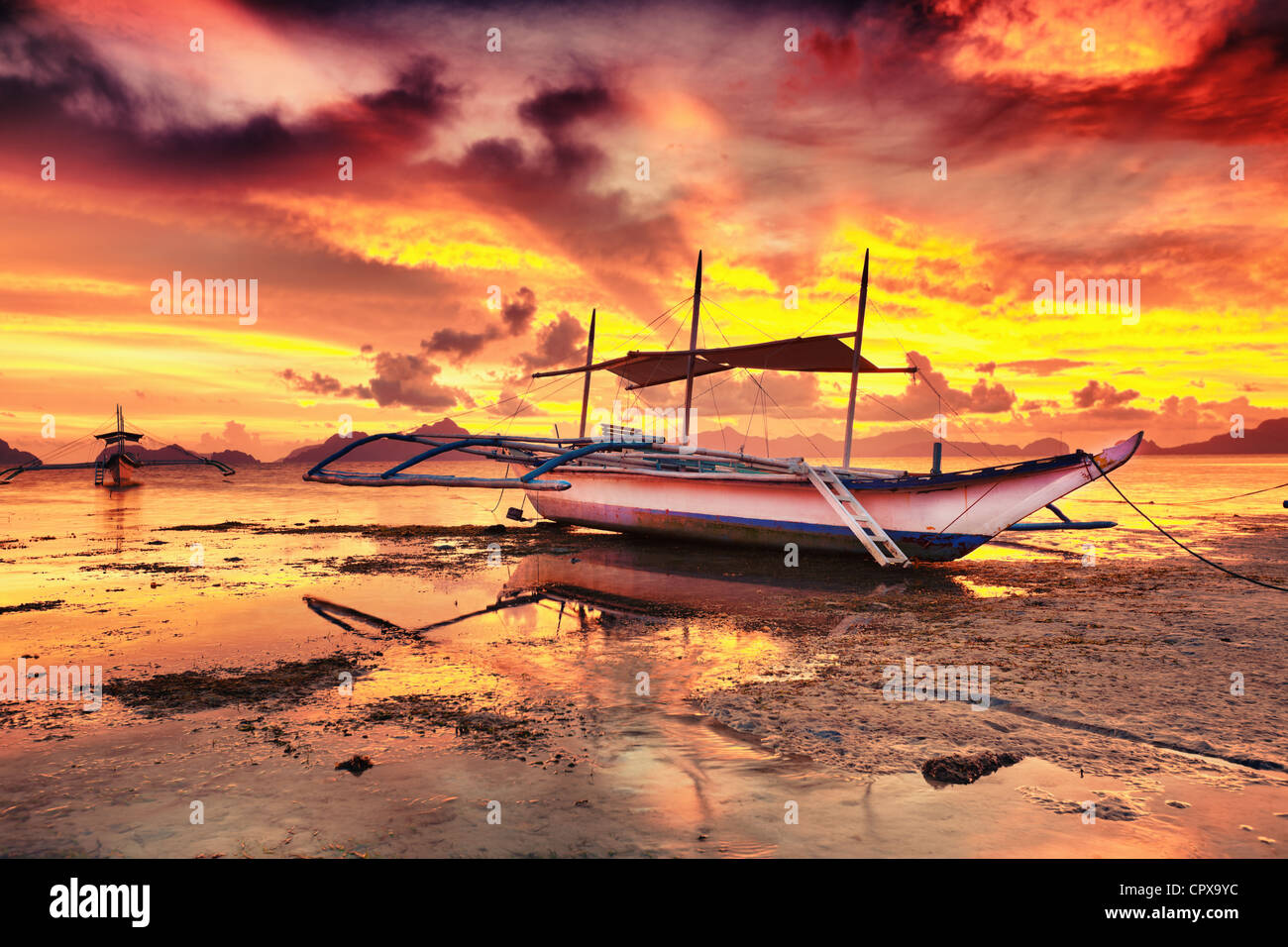 Traditional philippine boat bangka at sunset time Stock Photo