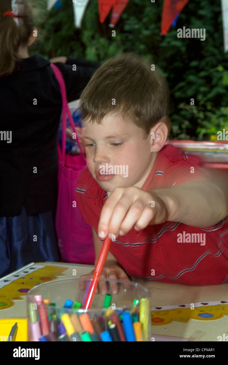 Young boy using crayons for making crowns for the Queen's Diamond Jubilee, Rowledge Village Stock Photo