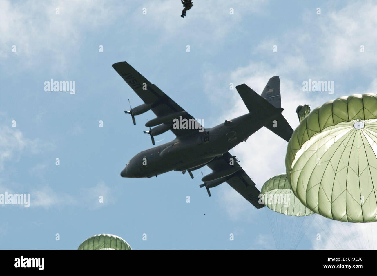 Task Force 68, which is made up of paratroopers from U.S., Germany, France, Holland, and United Kingdom, re-enacted the D-Day airborne operation on the La Fiere fields near Ste. Mere Eglise, France to commemorate the heroic acts of the WWII paratroopers who made the jump 68 years ago. After the jump, the task force marched into the town of Ste. Mere Eglise tothe sounds of cheers from the locals. Task Force 68 is in Normandy, France to commemorate the 68th annivesary of D-Day. Stock Photo