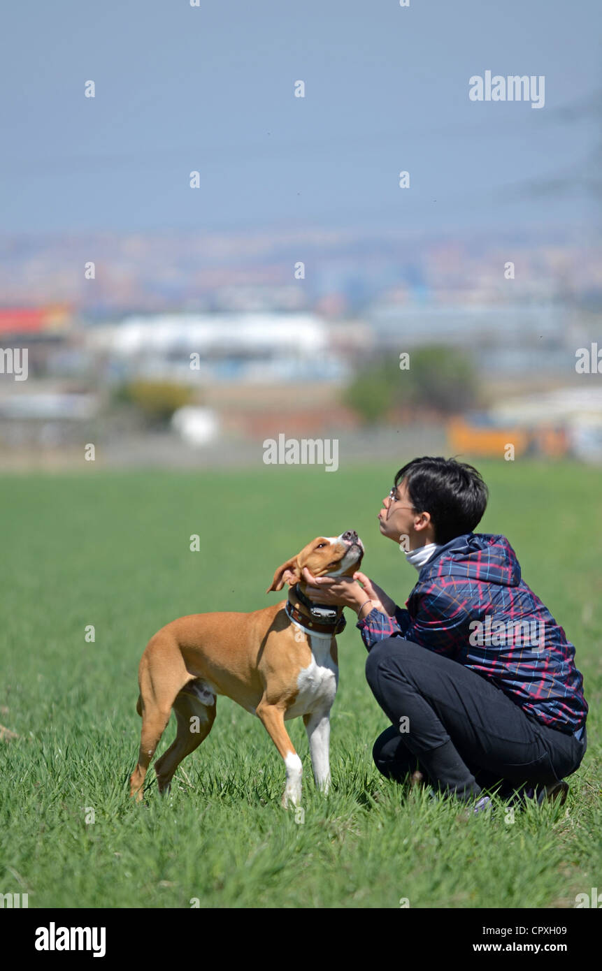 Young Short Haired Woman Hugs And Gives Affection To Her Dog Stock