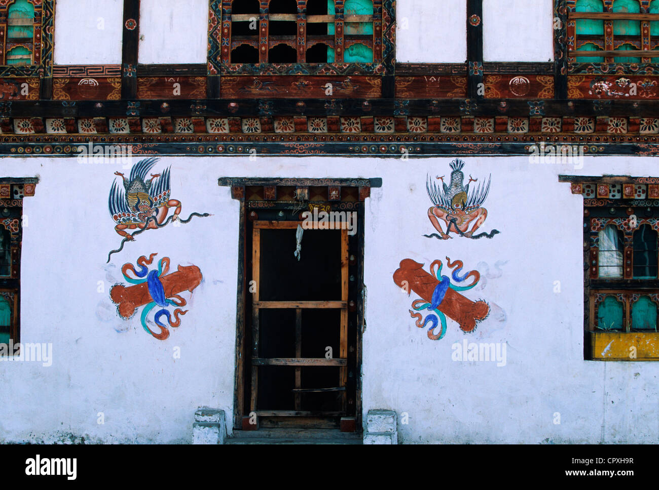 Bhutan traditional wooden rammed earth house phalluses painted on Bhutanese homes are meant to bring fertility protect family Stock Photo