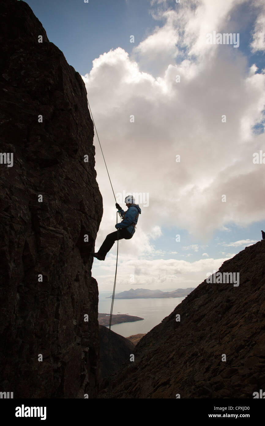 Climbers abseiling from the summit of the Inaccessible Pinnacle onto Sgurr Dearg in the Cuillin mountains, Stock Photo