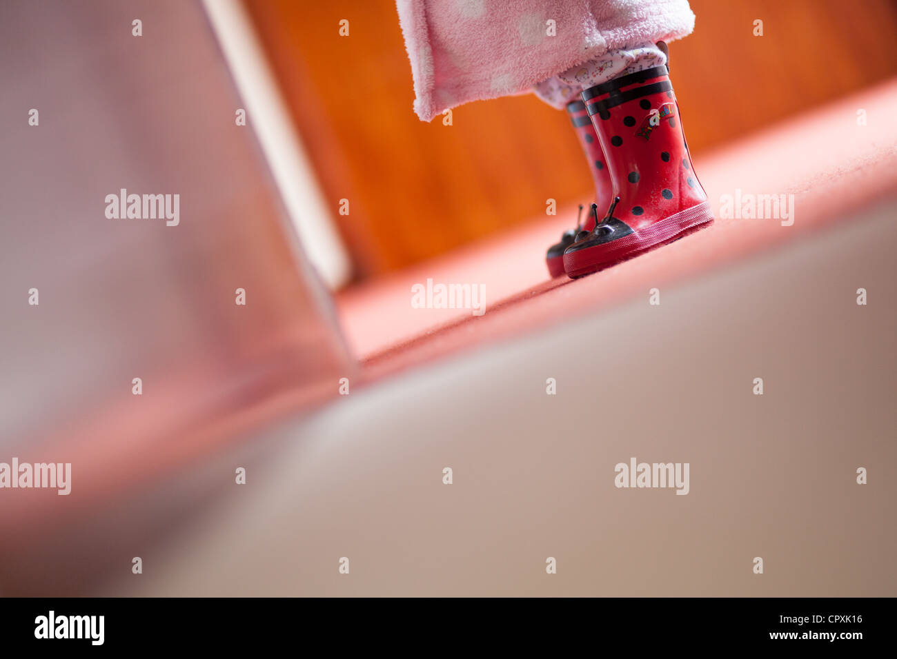 child in wellington boots and bathrobe indoors Stock Photo - Alamy