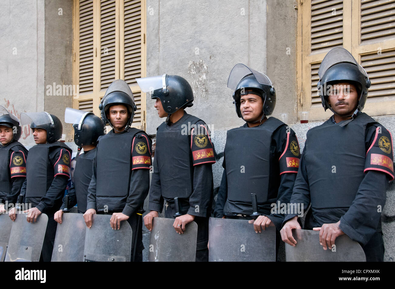 Egyptian security forces in riot gear waiting next to demonstration in