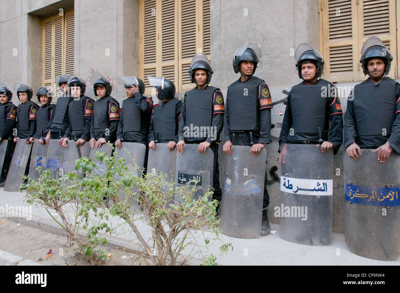 Egyptian security forces in riot gear waiting next to demonstration in