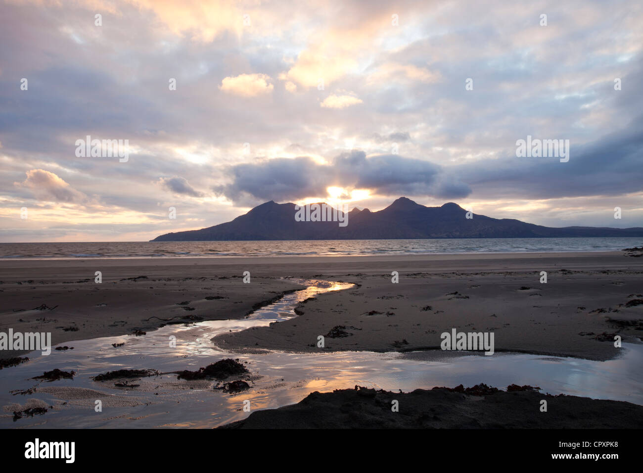 The Bay of Laig at Cleadale on the Isle of Eigg, looking towards the Isle of Rhum, Scotland, UK at sunset. Stock Photo