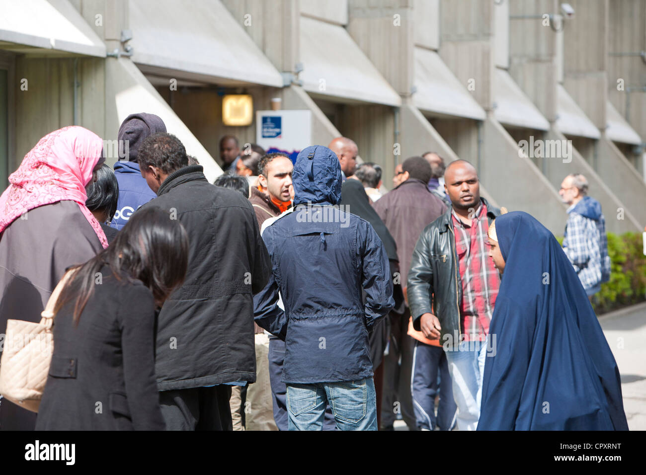 Immigrants queueing up at the UK Border Agency offices in London, UK. Stock Photo
