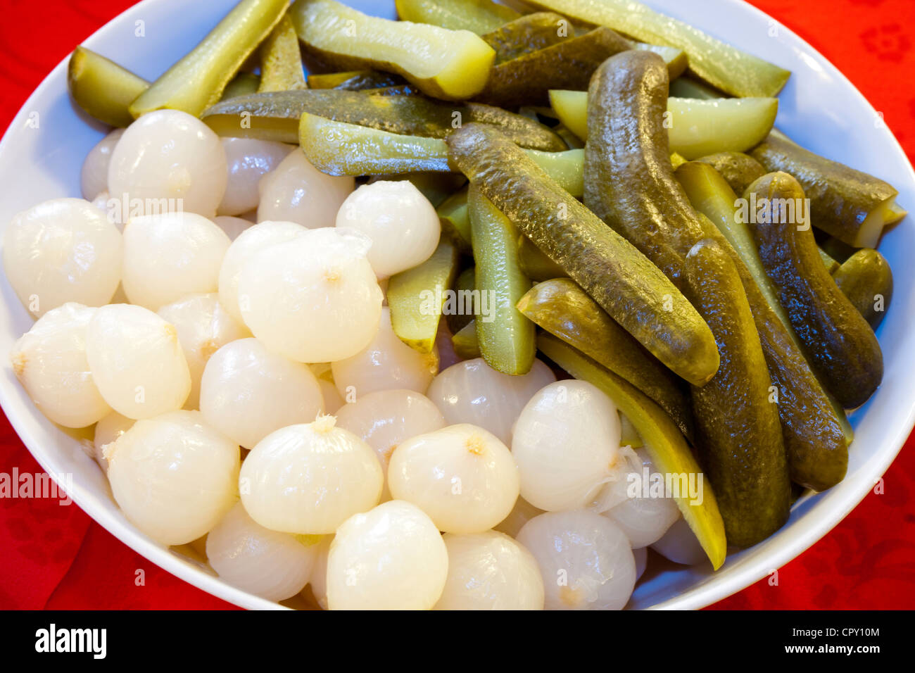 a plate of pearl onions and pickles Stock Photo