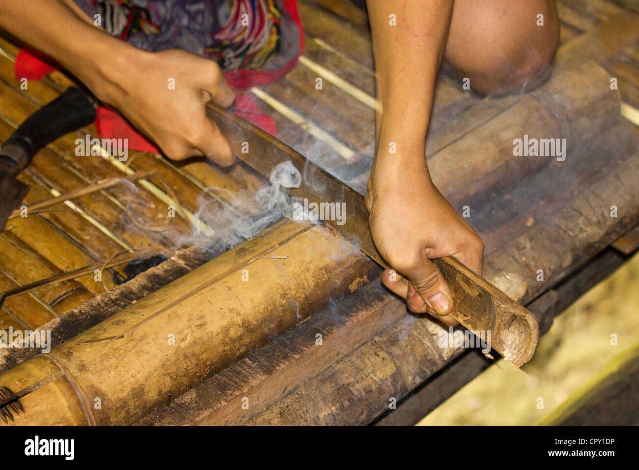 Starting a fire from a piece of Bamboo by hand, using a sideways motion