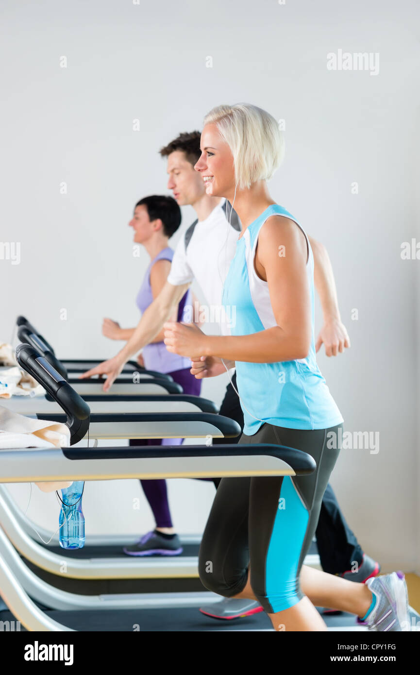 Running on treadmill young people exercise at fitness center Stock Photo