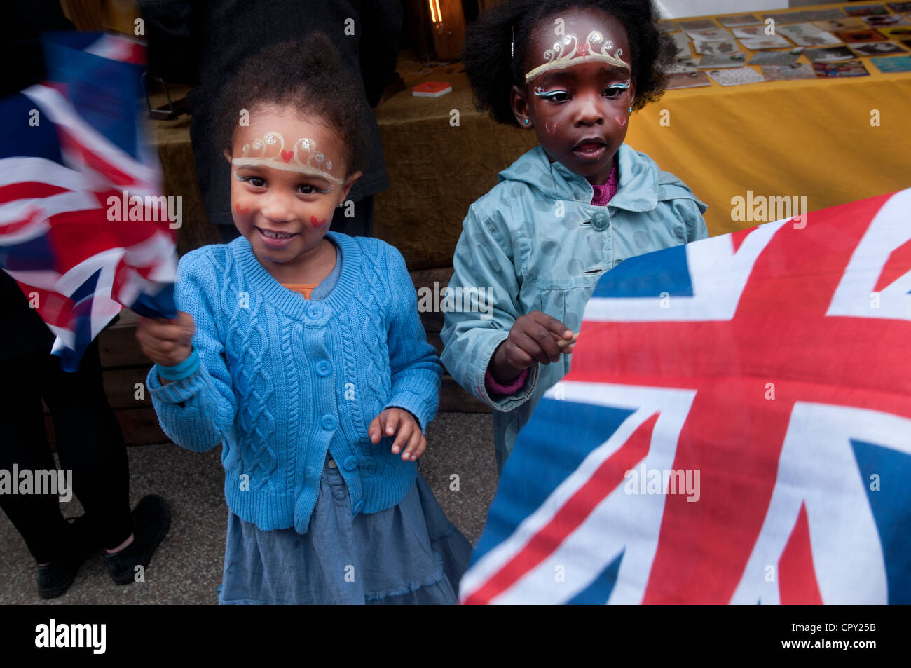 Rivington Street party, Shoreditch, London. Two young girls waving union jacks and face paint tiaras Stock Photo