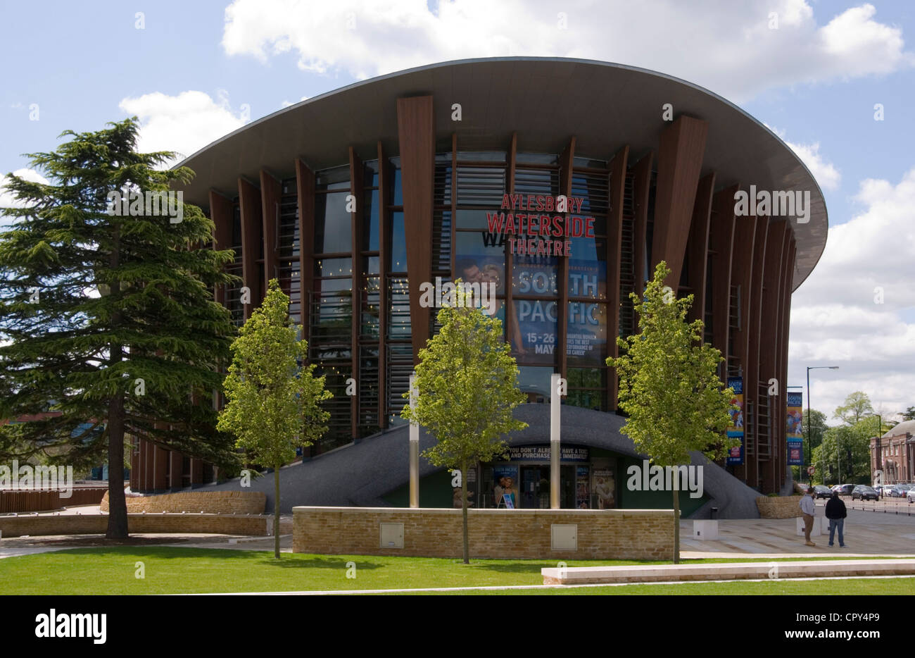 Bucks - Aylesbury - the Waterside theatre - main facade and entrance - tres - gardens -sunlight - blue sky Stock Photo