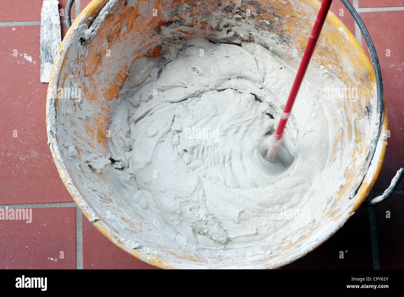 mixing Tile adhesive with a power drill Stock Photo Alamy