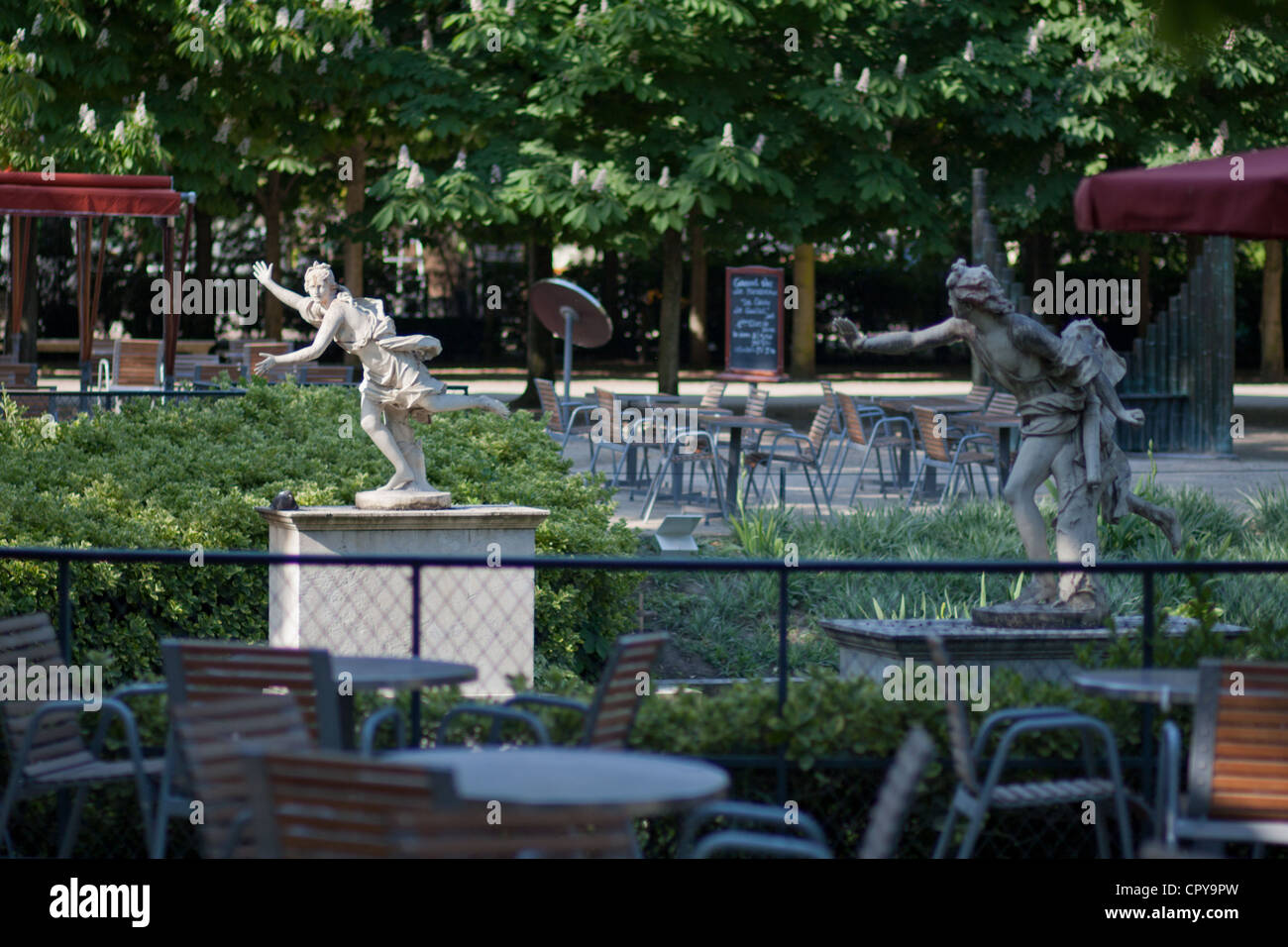 A pair of statues in the Tuileries Gardens who appear to be chasing each other, in perpetuity Stock Photo