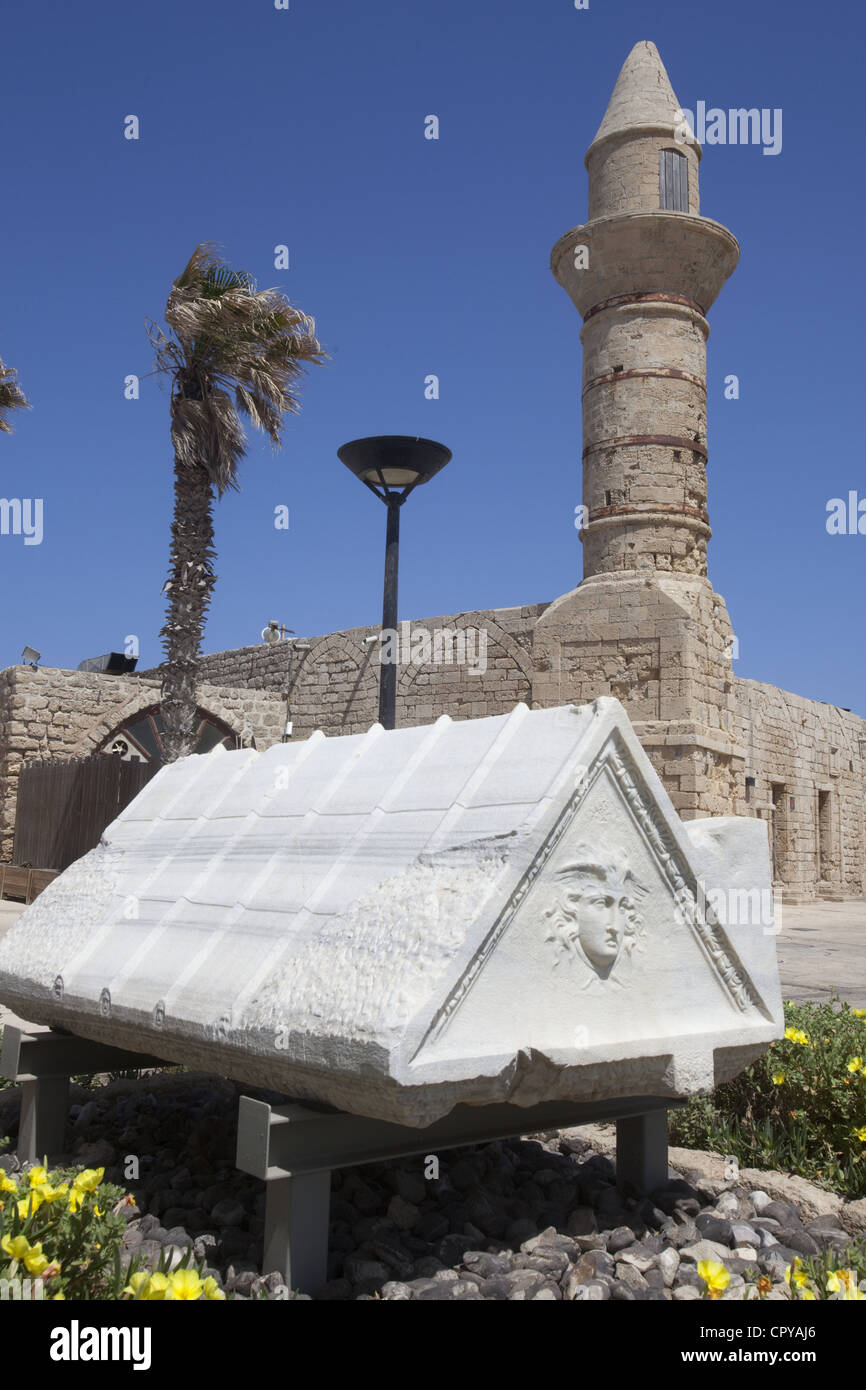 An ancient sarcophagus and the 19th century Bosnian Mosque at Caesarea Maritima, Israel Stock Photo