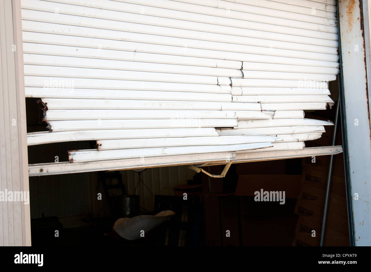 Up and over garage door which has been smashed Stock Photo Alamy