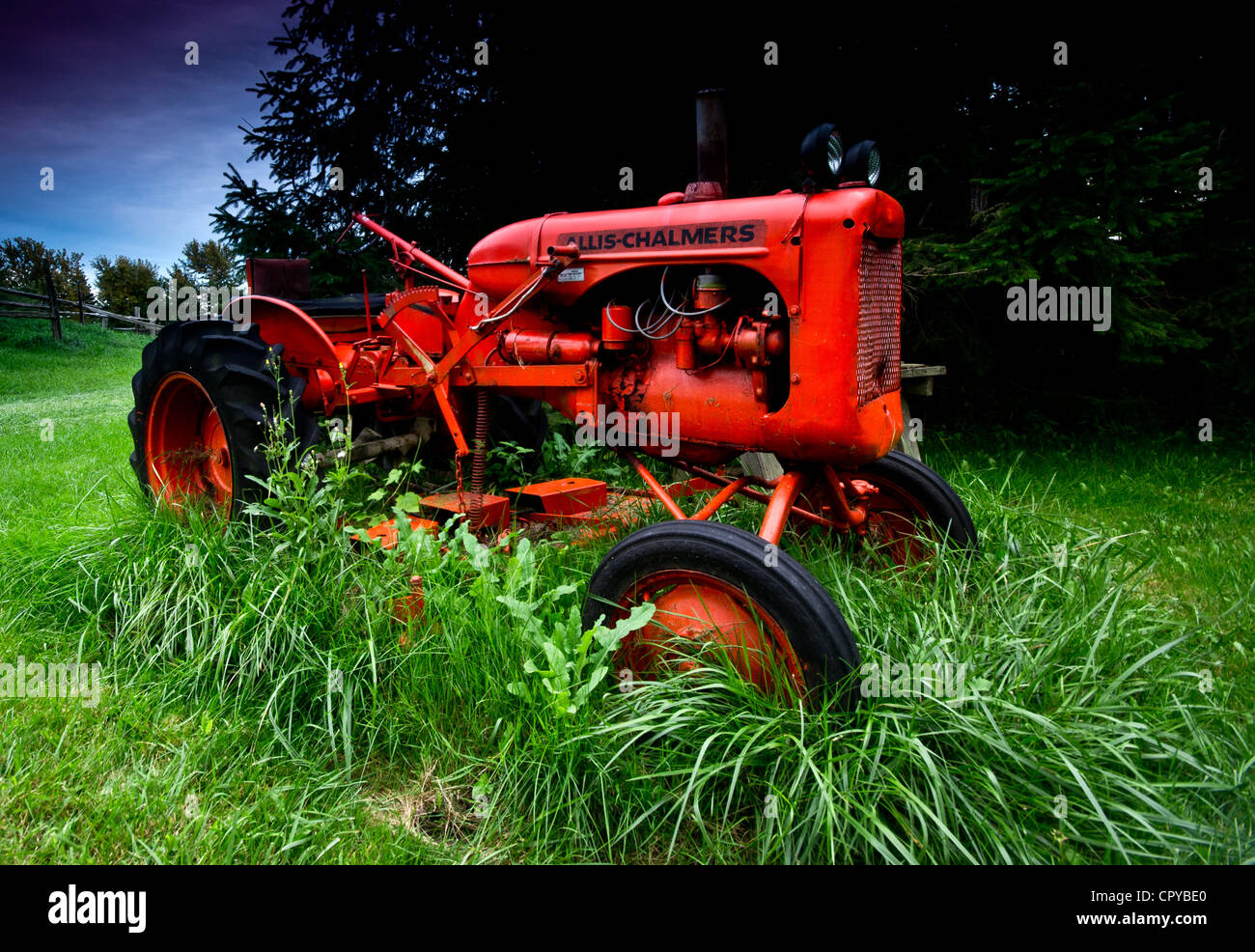 An Allis-Chalmers tractor in tall grass. Stock Photo
