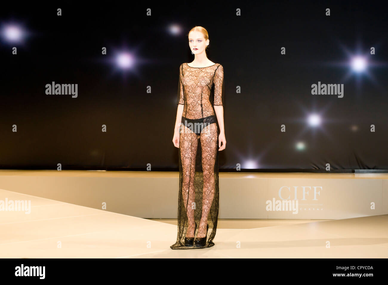 Young woman showing transparent dress at Copenhagen International Fashion  Fair Stock Photo - Alamy