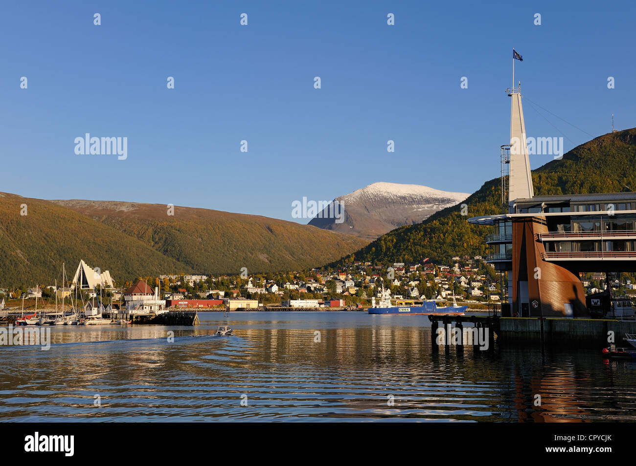Norway Troms County Tromso Rica Ishavshotell Hotel on harbour Arctic Cathedral and Tromsdalstind Mount (1238 m) in background Stock Photo