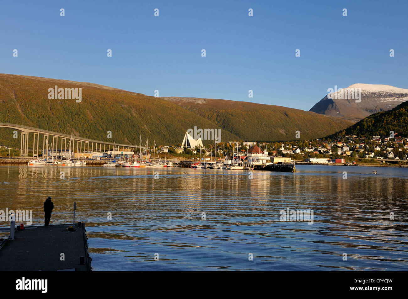 Norway Troms County Tromso harbour in Tromsesundet Fjord the Arctic Cathedral and Tromsdalstind Mount (1238 m) in the background Stock Photo