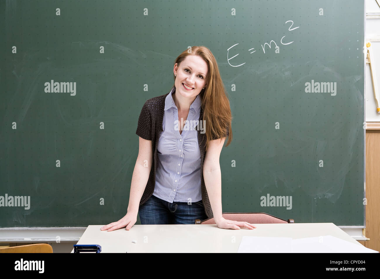 portrait of a young female teacher in the classroom Stock Photo