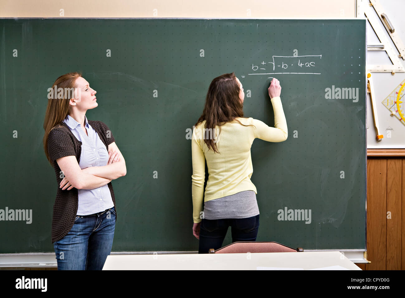 portrait of a young female teacher and a schoolgirl in the classroom Stock Photo