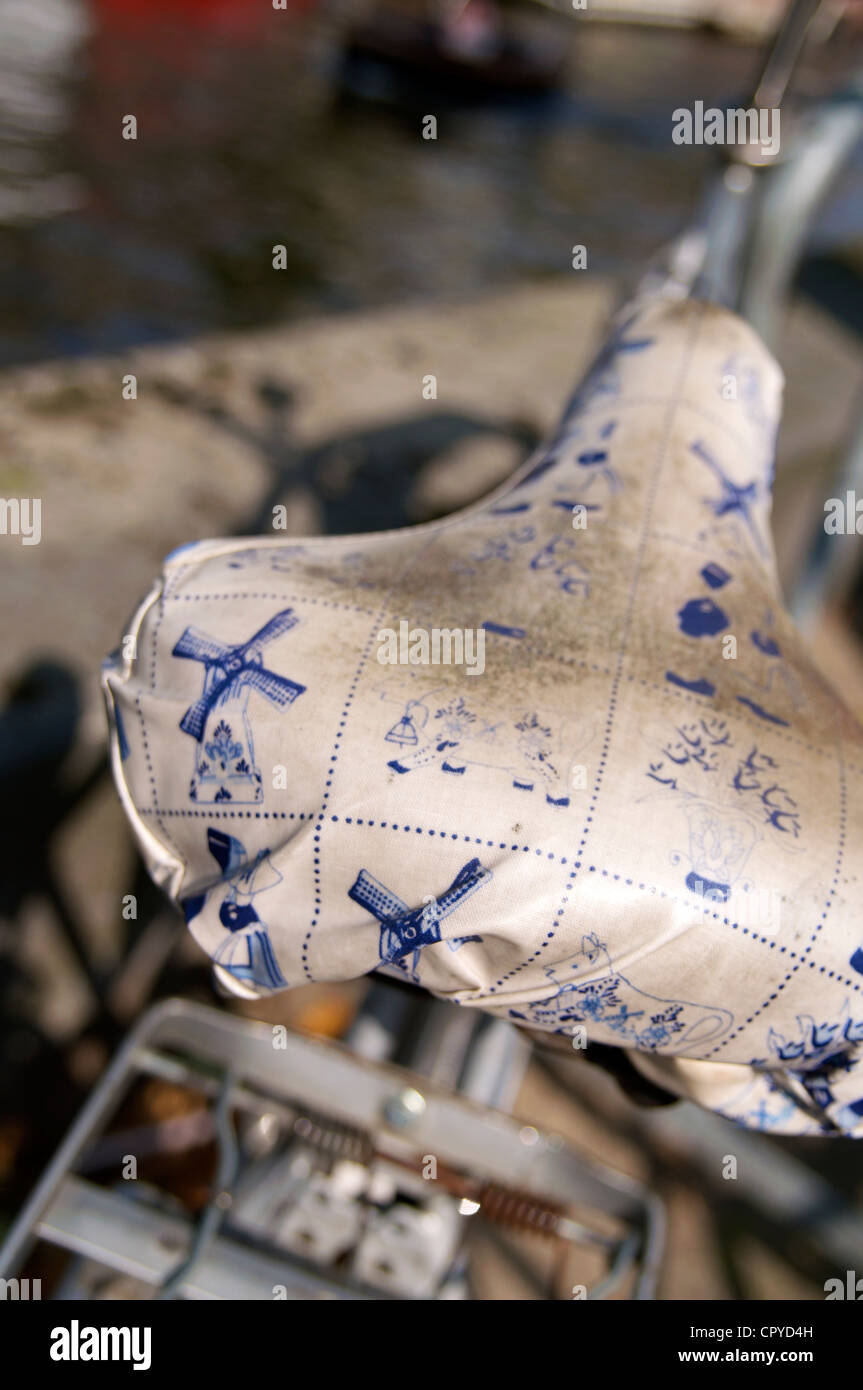 A bicycle saddle with a cover with a typical Dutch decoration in Amsterdam (The Netherlands). Stock Photo