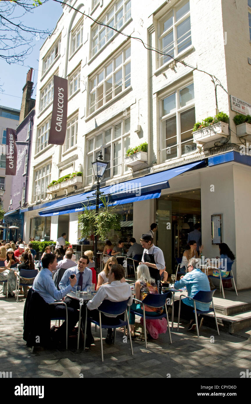 People outside Carluccio's, St. Christophers Place on a sunny day, London England UK Stock Photo