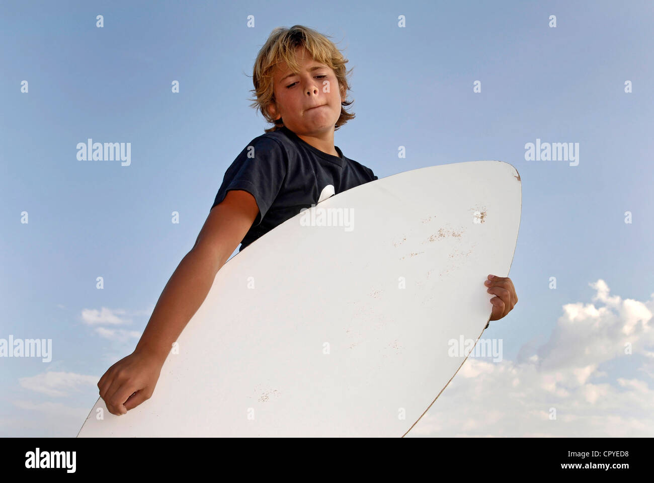 Boy posing in the beach with a skim-board Stock Photo - Alamy